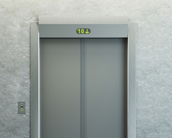 The exterior of a closed elevator that shows the elevator is currently on floor 10.
