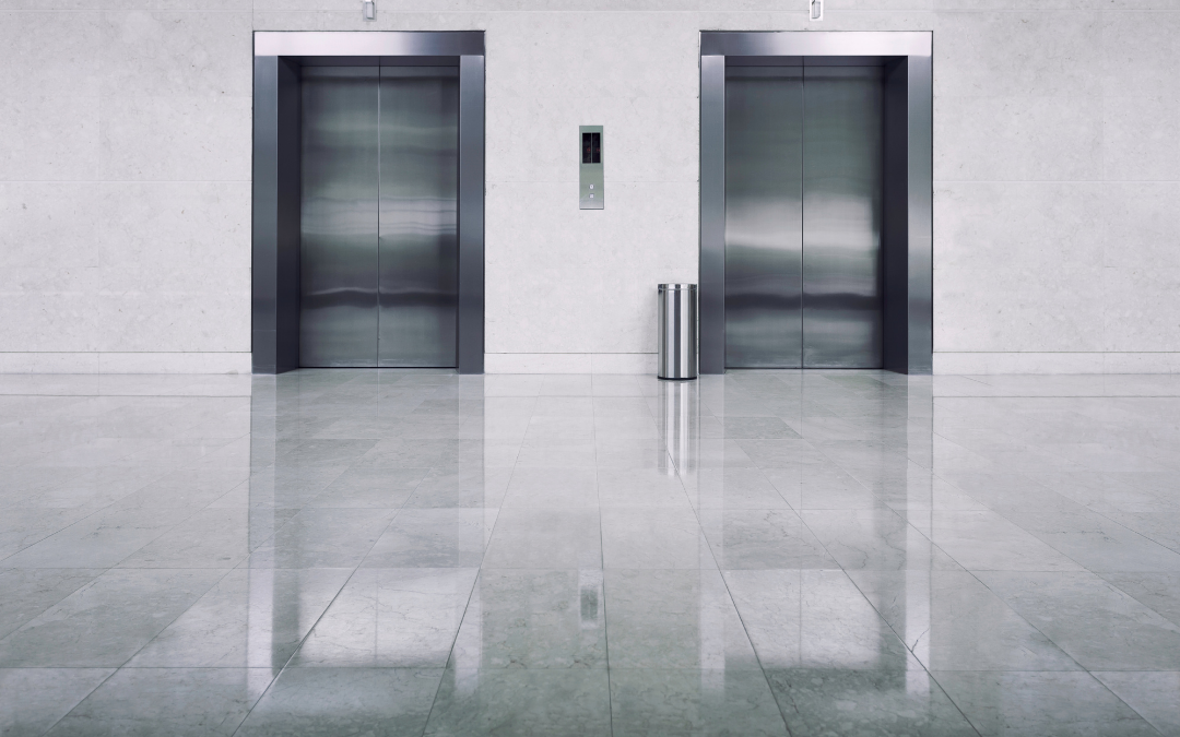The closed doors of two recently modernized elevators in the lobby of an office building