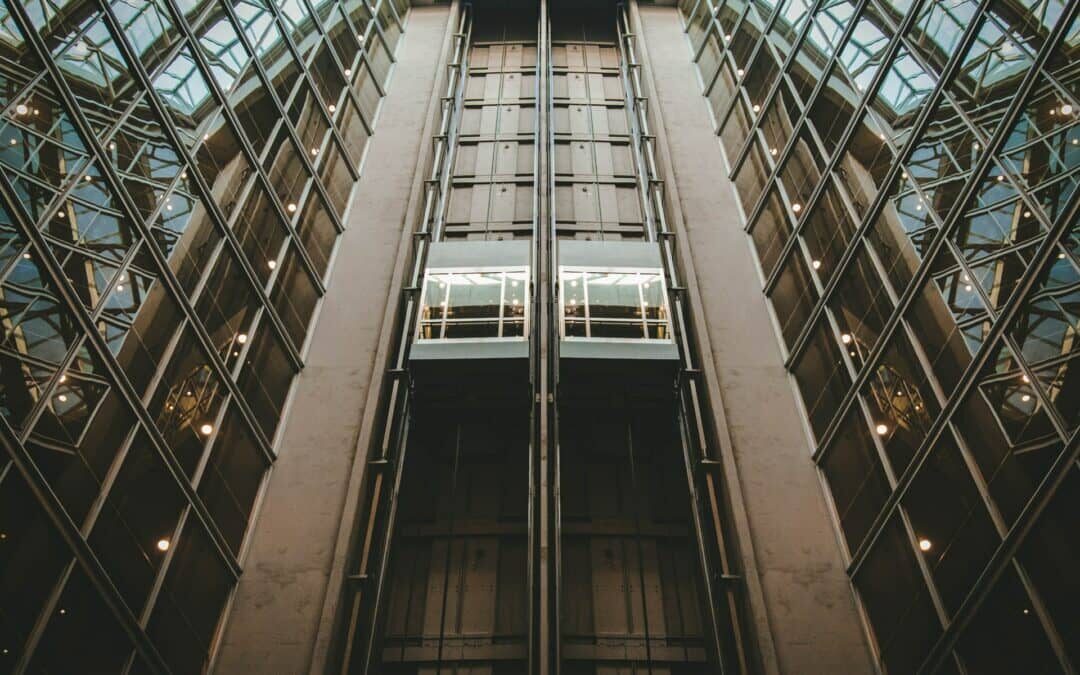 two elevators with windows in a multi-story building