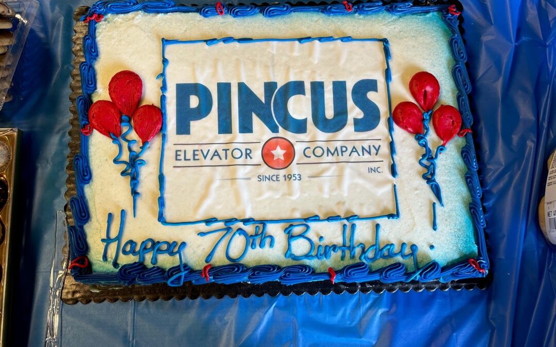 A birthday cake decorated with the Pincus Elevator logo and a message wishing the company a happy 70th birthday.